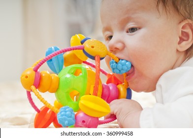 Little Baby Chewing A Toy