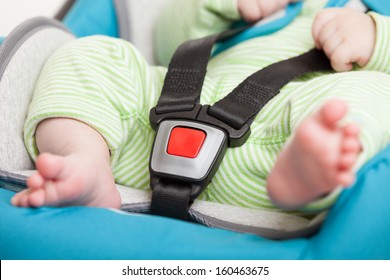 Little Baby Child Fastened With Security Belt In Safety Car Seat