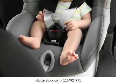 Little Baby In Child Safety Seat Inside Of Car, Closeup On Legs