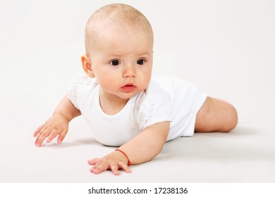 A little baby crawling on the floor