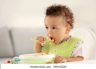 Little Baby Eating Fruit Puree Indoors