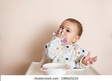 A Little Baby Eating Her Dinner And Making A Mess