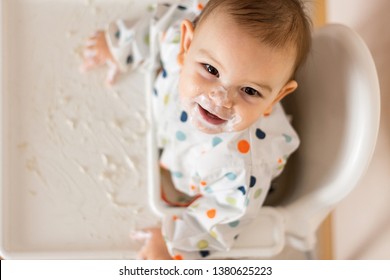 A Little Baby Eating Her Dinner And Making A Mess