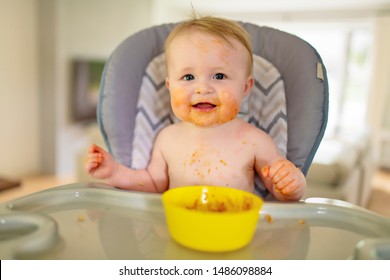 A Little Baby Eating Her Dinner And Making A Mess