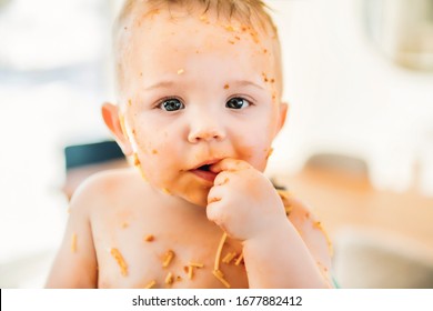 A Little Baby Eating Her Dinner And Making A Mess