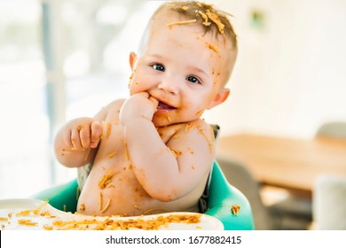 A Little Baby Eating Her Dinner And Making A Mess