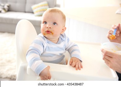 Little Baby Feeding With A Spoon