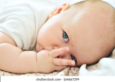 Little Baby With Finger In Mouth