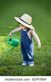 Little Baby Gardener Lost In The Moment With The Sun Shinning In His Face While He Works Hard