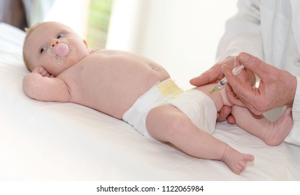 Little Baby Getting A Vaccine Shot In Leg