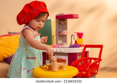 Little baby girl cooking plays educational plastic groceries toys in modern kitchen. The development of children at an early age. Educational toys for young children. Kindergarten, nursery.Toddler. - Shutterstock ID 2118631532