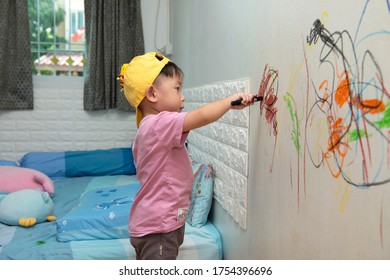  Little Baby Girl Drawing With Crayon Color On The Wall