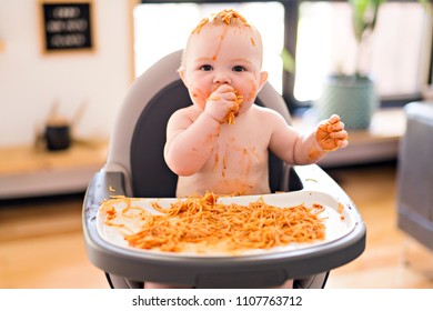 Little Baby Girl Eating Her Spaghetti Dinner And Making A Mess