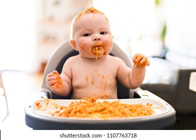 Little Baby Girl Eating Her Spaghetti Dinner And Making A Mess