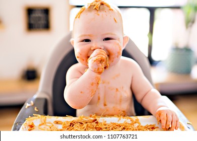 Little Baby Girl Eating Her Spaghetti Dinner And Making A Mess