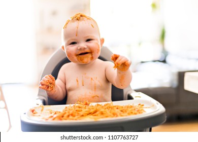 Little Baby Girl Eating Her Spaghetti Dinner And Making A Mess