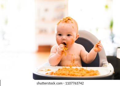 Little Baby Girl Eating Her Spaghetti Dinner And Making A Mess