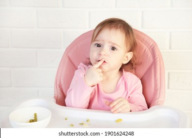 Little Baby Girl Eating Her Dinner And Making A Mess. Top View