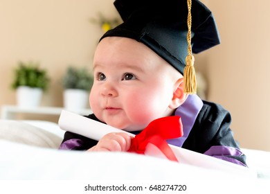 Little Baby Girl In Graduation Cap And Gown