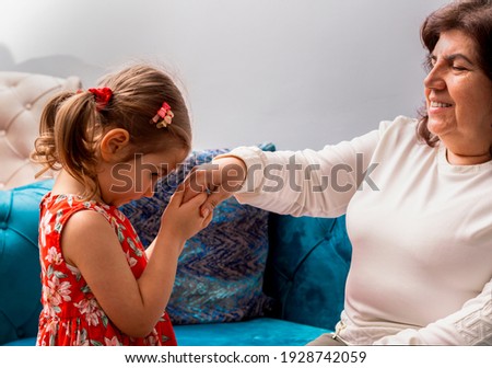 Image, Stock Photo Little girl kissing her mother lying on bed and enjoy the time at home. Mother’s Day or mother’s love concept image