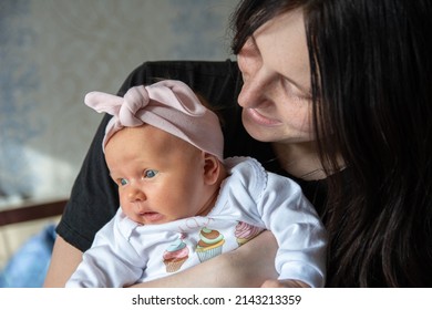 Little baby girl with mom, closeup portrait. Caucasian child and mom.