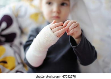 Little baby girl showing her bandaged hand - Powered by Shutterstock