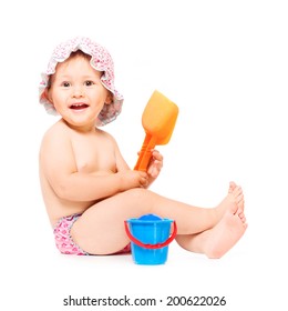 Little Baby Girl Siting In Swimming Pants And Sunhat, Isolated Over White