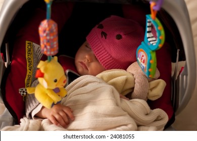 Little Baby Girl Sleeping In Car Seat.