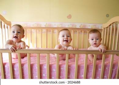 Little Baby Girls In Crib Together - Triplets