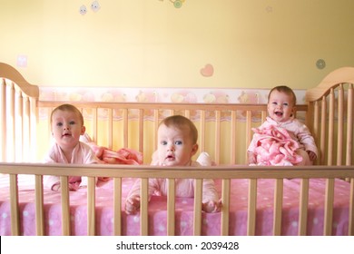 Little Baby Girls In Crib Together - Triplets