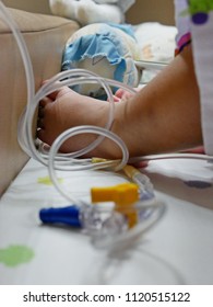 Little Baby Girl's Foot In Tangled Intravenous (IV) Line - Serious Accident Could Happen If The Catheter Is Pulled Out Of The Vein