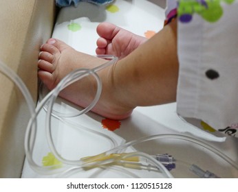 Little Baby Girl's Foot In Tangled Intravenous (IV) Line - Serious Accident Could Happen If The Catheter Is Pulled Out Of The Vein