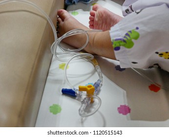 Little Baby Girl's Foot In Tangled Intravenous (IV) Line - Serious Accident Could Happen If The Catheter Is Pulled Out Of The Vein