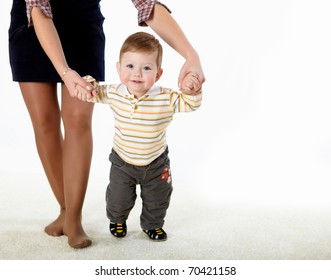 Little Baby Learning How To Walk With A Parent