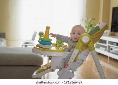 little baby playing with toys while dad works at home. global pandemic covid-19
