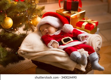 Little Baby Santa Sleeping Under Christmas Tree With Presents