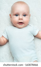 Little Baby  In A Shirt On The White Carpet