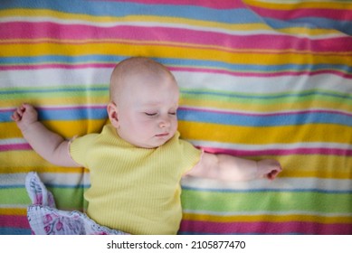 A Little Baby Sleeping Outside On A Blanket