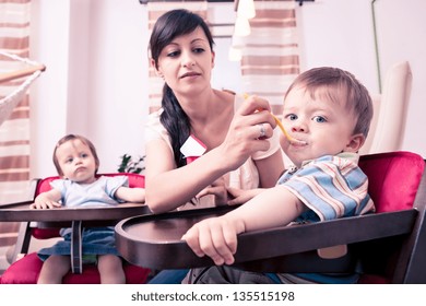 Little Baby Twins Eating A Yougurt