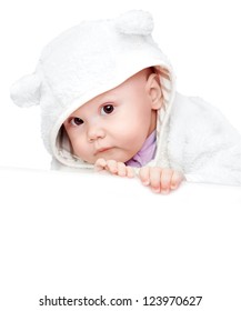 little baby in white bear costume isolated on white background with empty white board