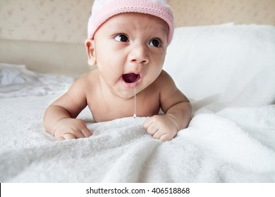 Little Baby Yawns In Bed With Saliva