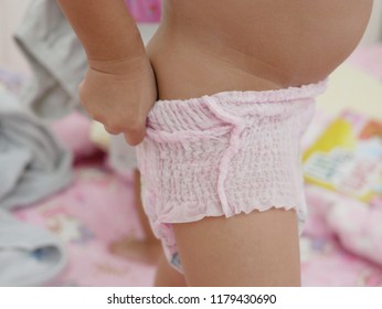 Little Baby's Hands Pulling A Diaper Up / Putting It On By Herself - Child Development By Allowing Them To Do Things By Themselves