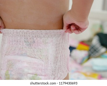 Little Baby's Hands Pulling A Diaper Up / Putting It On By Herself - Child Development By Allowing Them To Do Things By Themselves