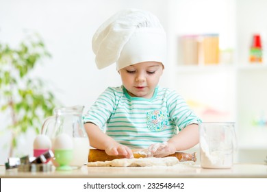 Little Baker Kid Girl In Chef Hat At Kitchen