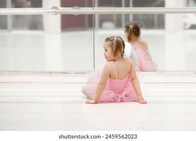 Little ballerina girl in a pink tutu. Adorable child dancing classical ballet in a white studio. Children dance. Kids performing. Young gifted dancer in a class. Preschool kid taking art lessons. - Powered by Shutterstock