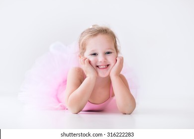 Little Ballerina Girl In A Pink Tutu. Adorable Child Dancing Classical Ballet In A White Studio. Children Dance. Kids Performing. Young Gifted Dancer In A Class. Preschool Kid Taking Art Lessons.