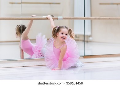 Little Ballerina Girl In A Pink Tutu. Adorable Child Dancing Classical Ballet In A White Studio. Children Dance. Kids Performing. Young Gifted Dancer In A Class. Preschool Kid Taking Art Lessons.