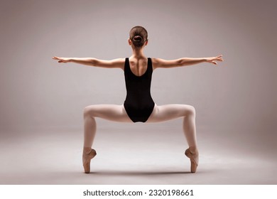 Little Ballerina Teen Dancer posing  in Pointe Shoes and Black Leotard Back to Camera in Studio Background. - Powered by Shutterstock