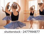Little ballerinas perform at a dance school. 