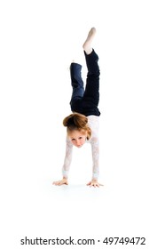 Little ballet dancer make handstand isolated on a white background
